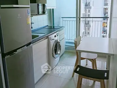 Modern kitchen with washing machine and balcony view in high-rise apartment