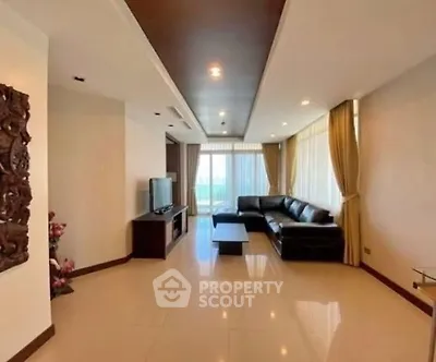 Spacious living room with modern decor and large windows offering natural light.