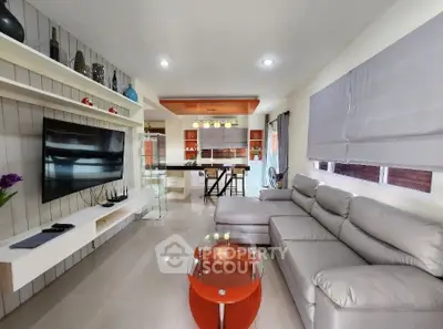 Modern living room with sleek furniture and open kitchen layout