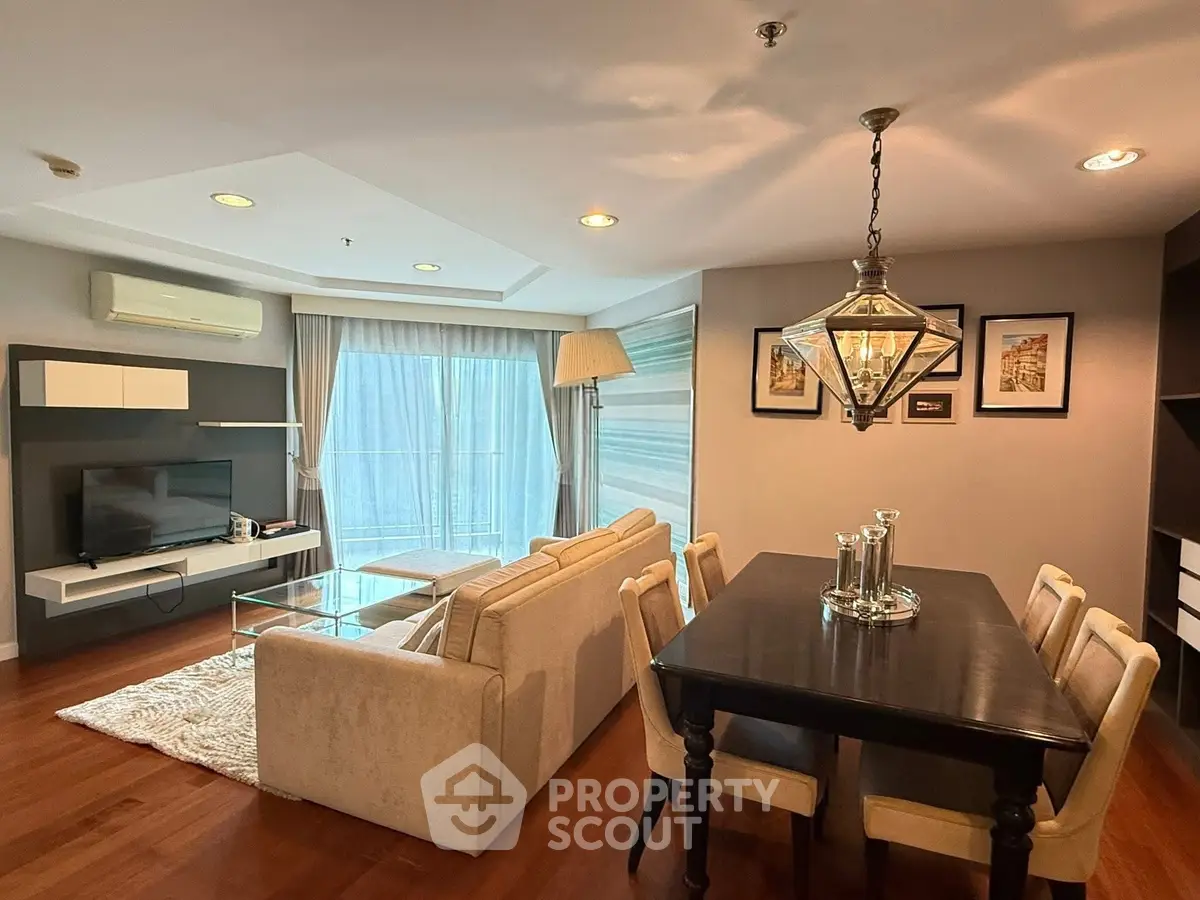 Spacious living room with elegant dining area and modern decor in a stylish apartment.