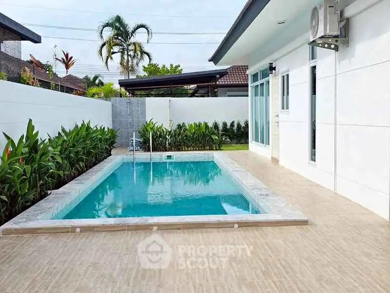 Modern villa with private pool and lush greenery, perfect for relaxation and luxury living.