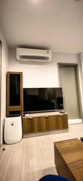 Modern living room with sleek TV setup and air conditioning