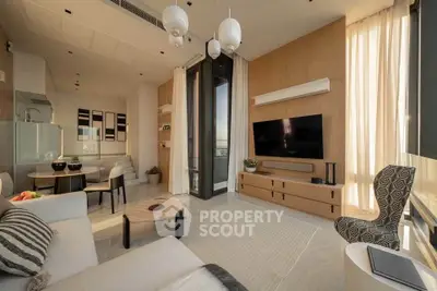 Modern living room with stylish decor and large windows offering natural light.