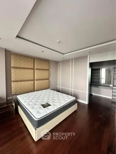 Spacious bedroom with modern design and hardwood flooring