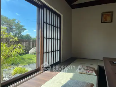 Serene Japanese-style room with tatami mats and garden view