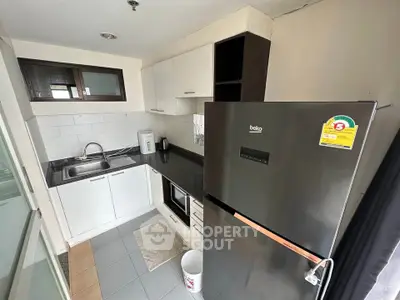 Modern compact kitchen with sleek appliances and stylish cabinetry