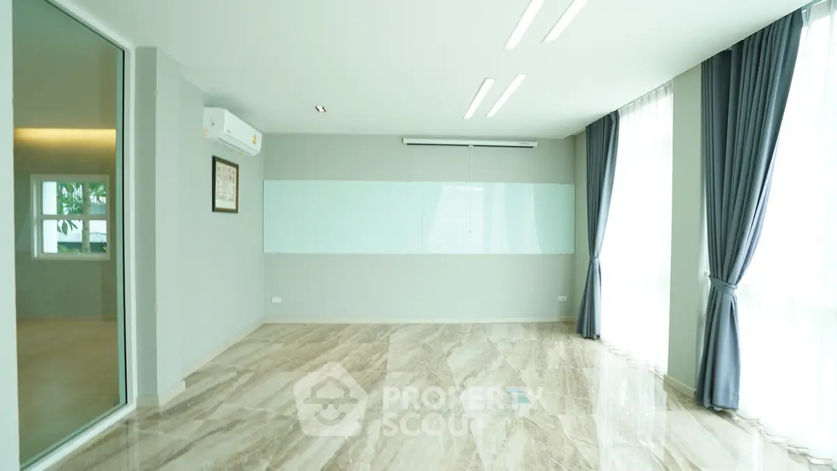 Spacious modern room with large windows and elegant marble flooring