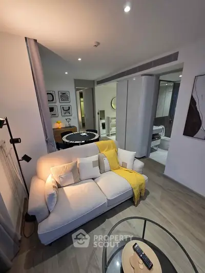 Modern living room with cozy sofa and stylish decor in open-plan apartment