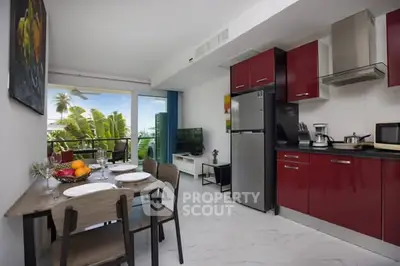 Modern kitchen and dining area with red cabinets and balcony view