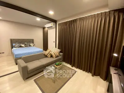 Modern studio apartment with cozy living area and stylish bedroom