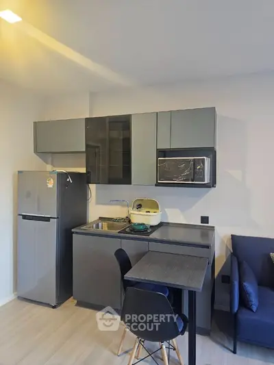 Modern compact kitchen with sleek cabinets and dining area