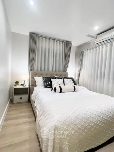 Cozy modern bedroom with elegant decor and soft lighting