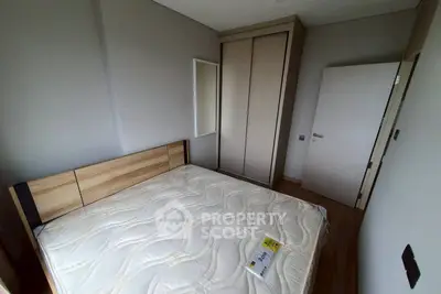Cozy bedroom with modern wardrobe and comfortable bed in a stylish apartment.