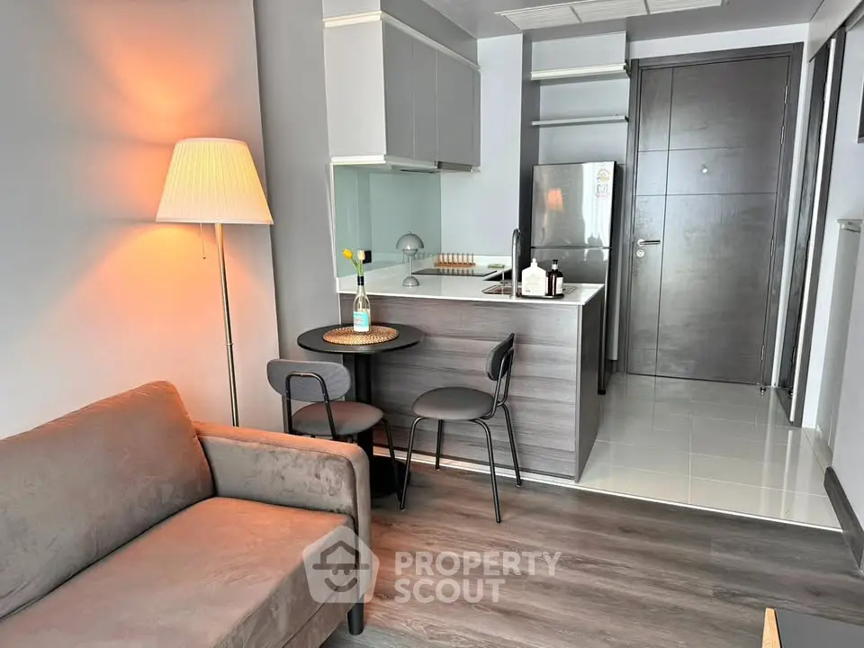 Modern studio apartment with cozy living area and compact kitchen