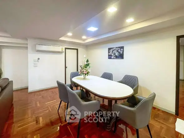 Elegant dining area with modern furniture and stylish lighting in a cozy apartment.