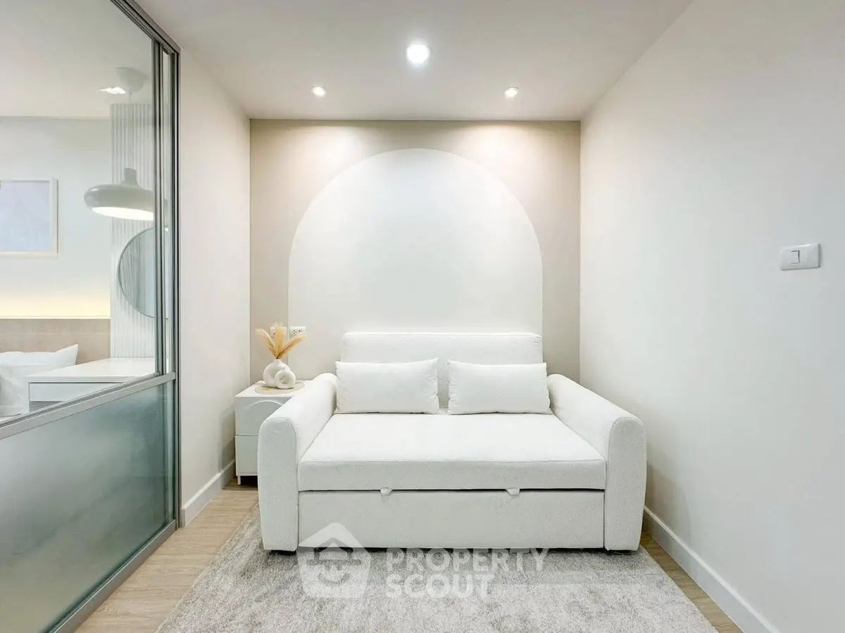 Modern minimalist living room with white sofa and soft lighting