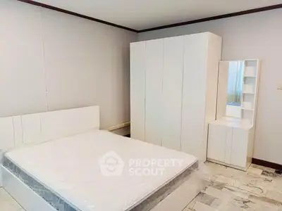 Modern bedroom with sleek white furniture and minimalist design, perfect for a serene living space.
