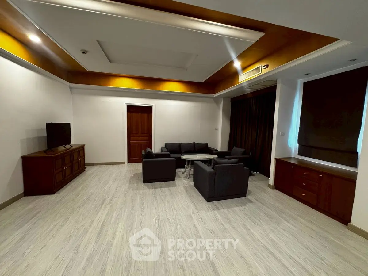 Spacious living room with modern furniture and elegant ceiling design