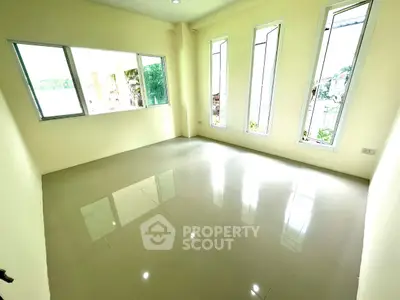 Bright empty room with large windows and glossy tiled floor, perfect for customization.