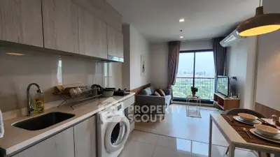 Modern open-plan living room with kitchen and city view, featuring sleek furniture and appliances.
