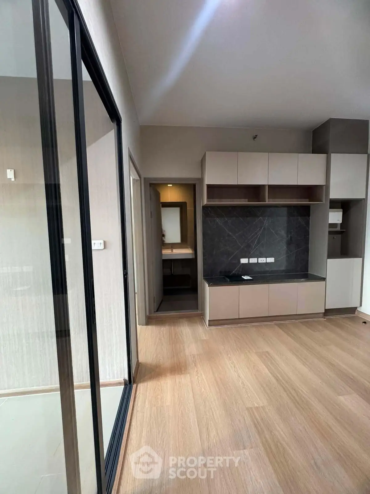 Modern interior with sleek cabinetry and wooden flooring, perfect for stylish living.