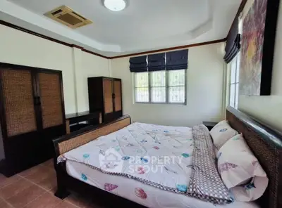 Spacious bedroom with elegant furniture and natural light