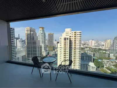 Stunning cityscape view from a modern balcony with seating area, perfect for relaxation.
