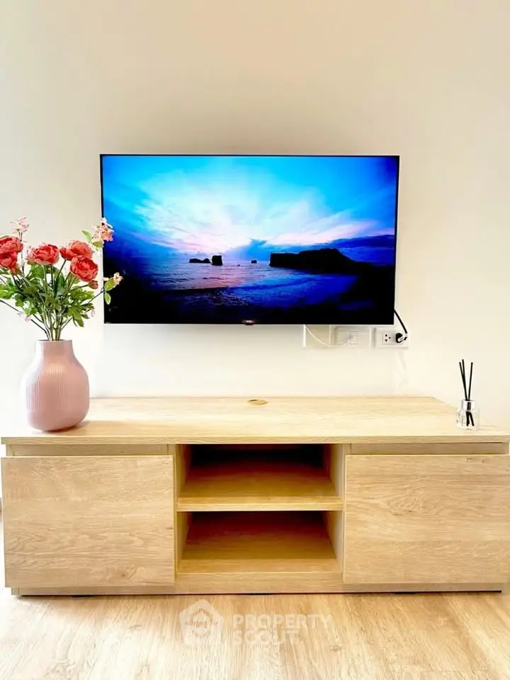 Modern living room with stylish TV setup and elegant wooden cabinet