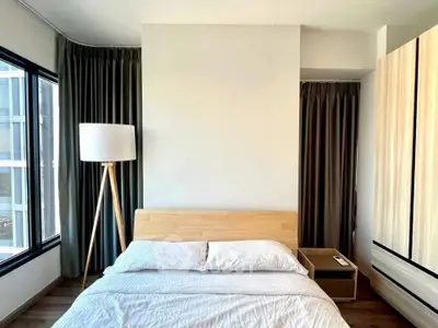 Modern bedroom with natural light and stylish wooden furniture