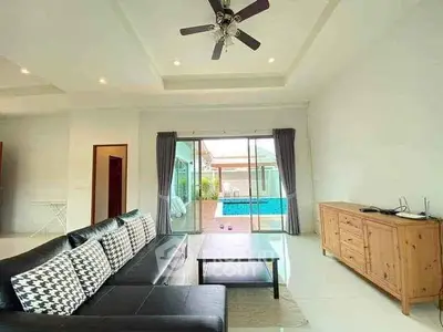 Spacious living room with pool view and modern furnishings