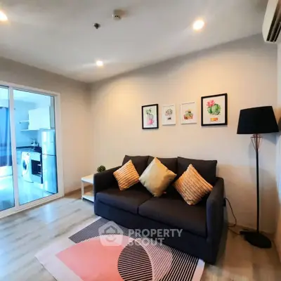 Modern living room with stylish decor and open view to kitchen area