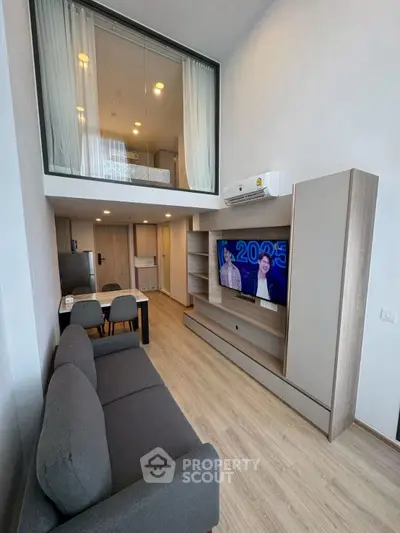 Modern duplex living room with sleek design and mezzanine bedroom