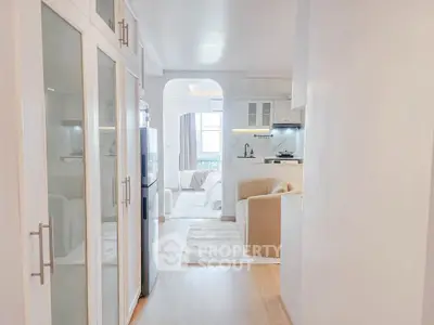 Bright and modern open-plan living space with sleek kitchen and cozy seating area.