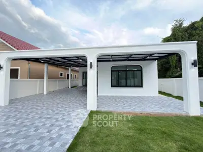 Modern single-story home with spacious carport and lush green lawn