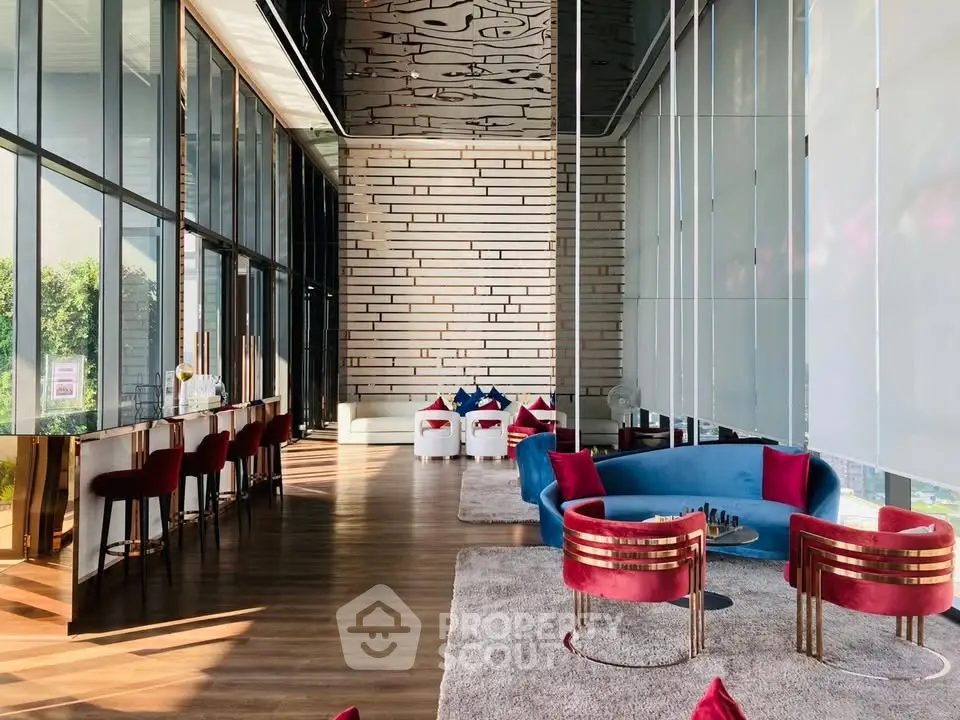 Luxurious modern lobby with stylish seating and floor-to-ceiling windows offering stunning views.