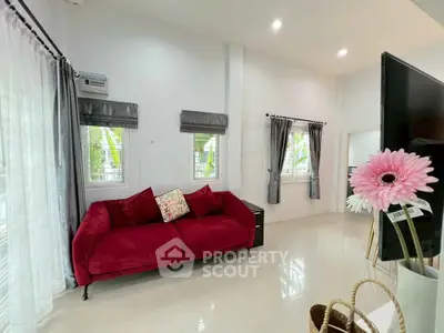 Bright living room with red sofa and modern decor