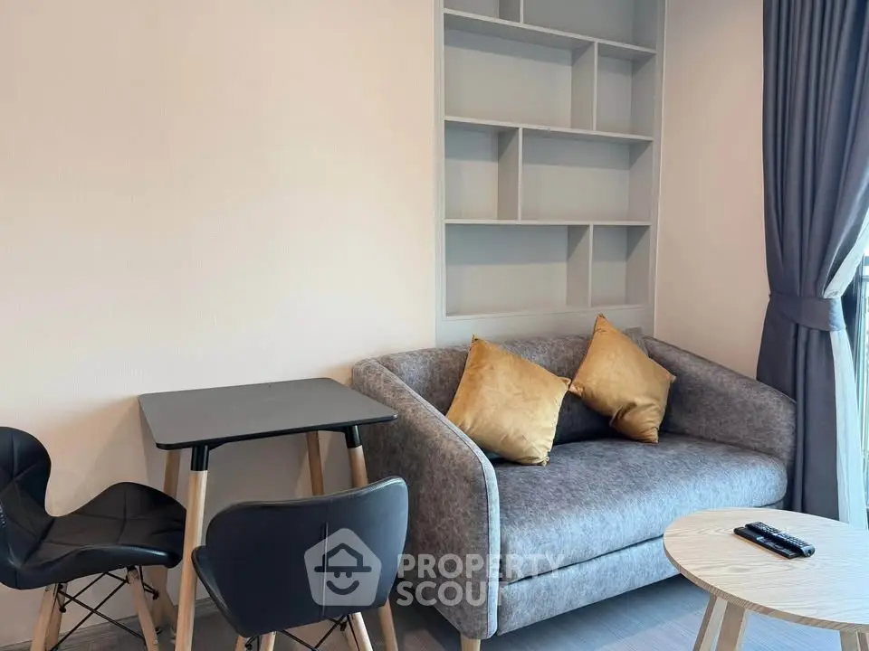 Modern living room with cozy sofa, stylish chairs, and built-in shelving, perfect for urban living.