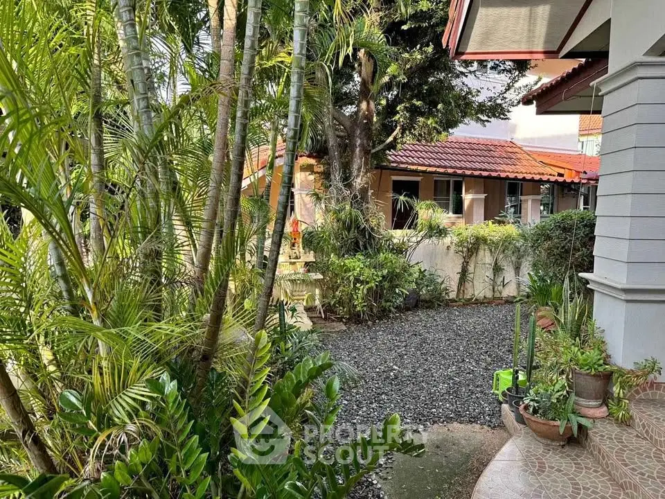 Charming garden view with lush greenery and cozy home exterior.