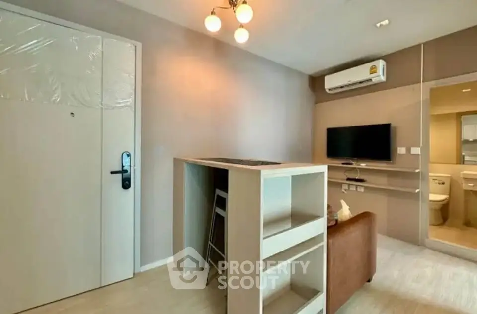 Modern living room with air conditioning and wall-mounted TV in a stylish apartment.