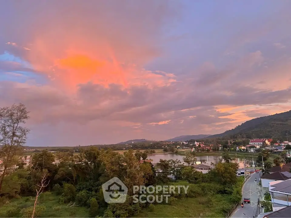 Stunning sunset view over lush greenery and serene lake, perfect for tranquil living.