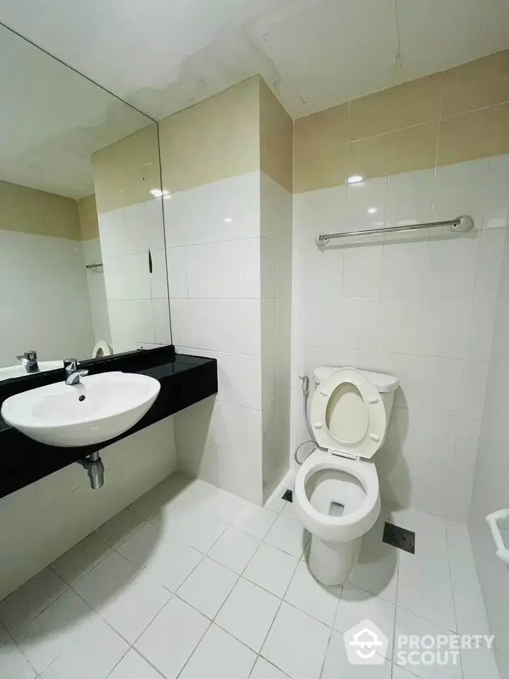 Modern bathroom with sleek white tiles and contemporary fixtures