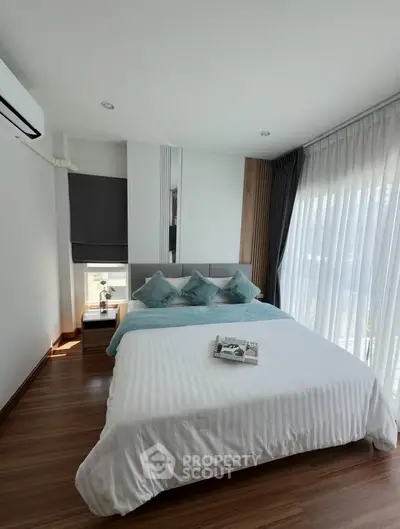 Modern bedroom with stylish decor and large windows for natural light