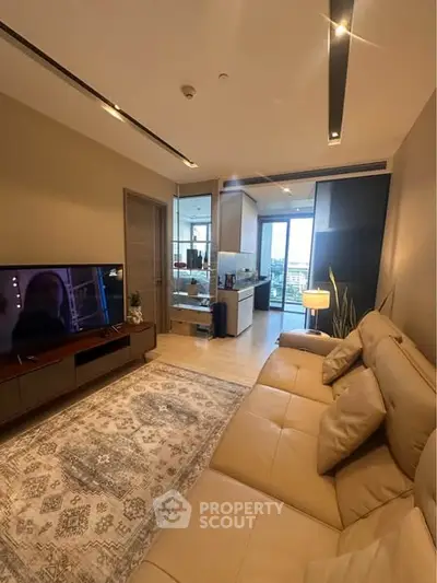 Modern living room with cozy beige sofa and open kitchen layout