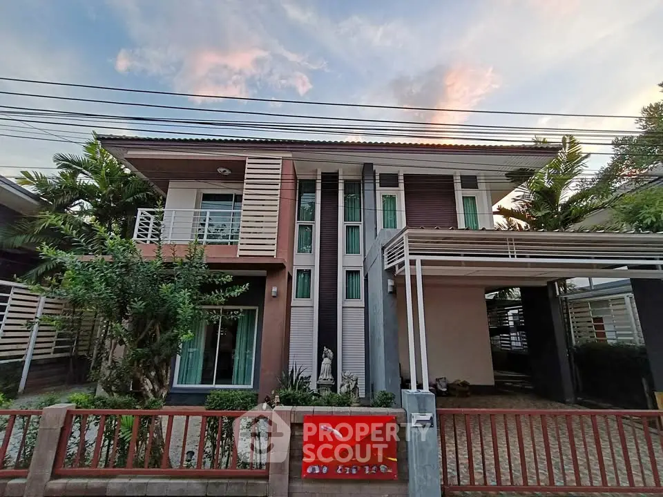 Modern two-story house with sleek design and lush greenery