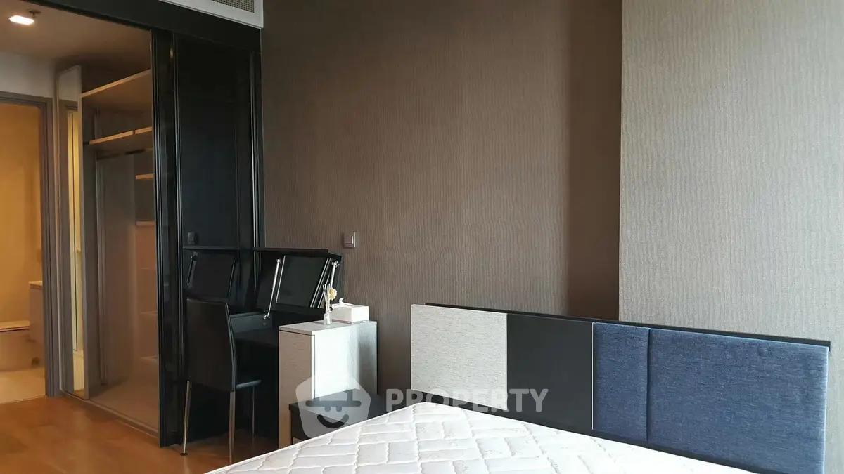 Modern bedroom with stylish headboard and cozy workspace