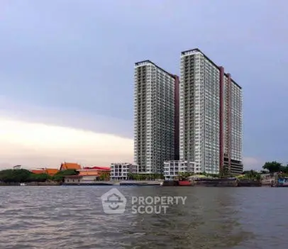Stunning riverside high-rise building with modern architecture and scenic views.