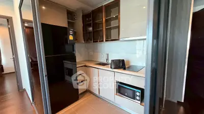 Modern kitchen with sleek cabinetry and built-in appliances in a stylish apartment.