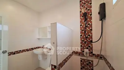Modern bathroom with stylish mosaic tiles and sleek fixtures