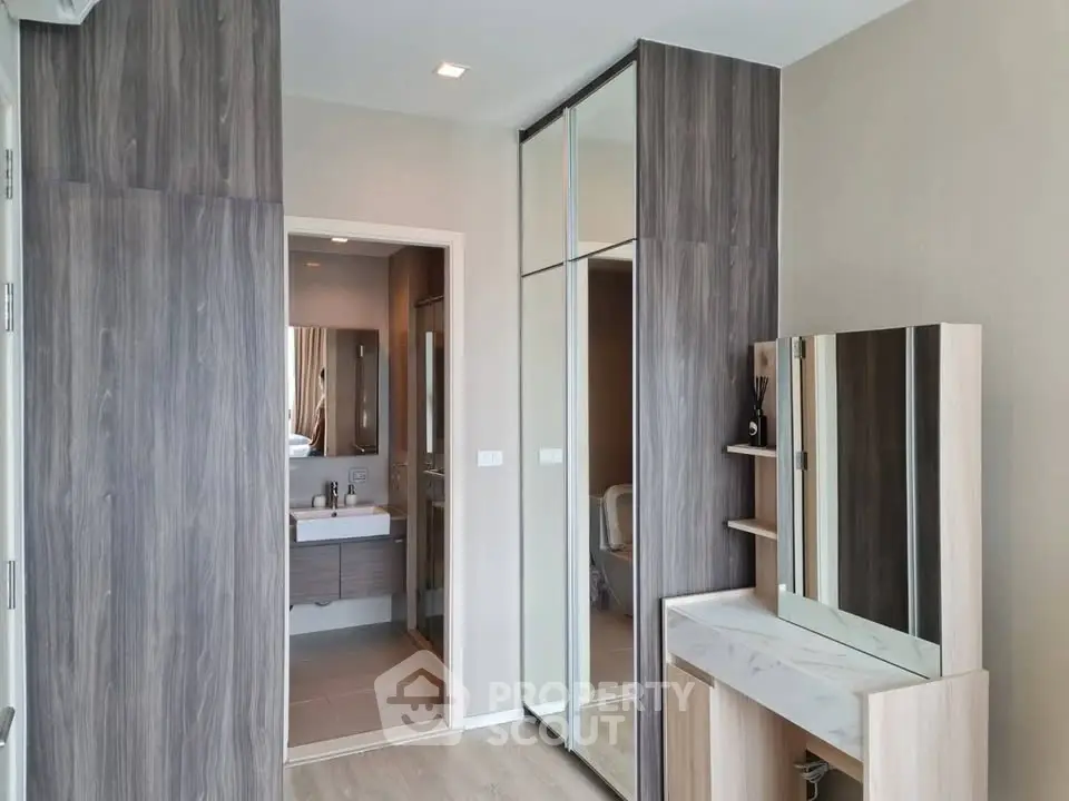 Modern bedroom with ensuite bathroom and stylish vanity in a contemporary apartment.