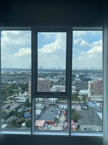 Stunning cityscape view from high-rise apartment window with expansive skyline.